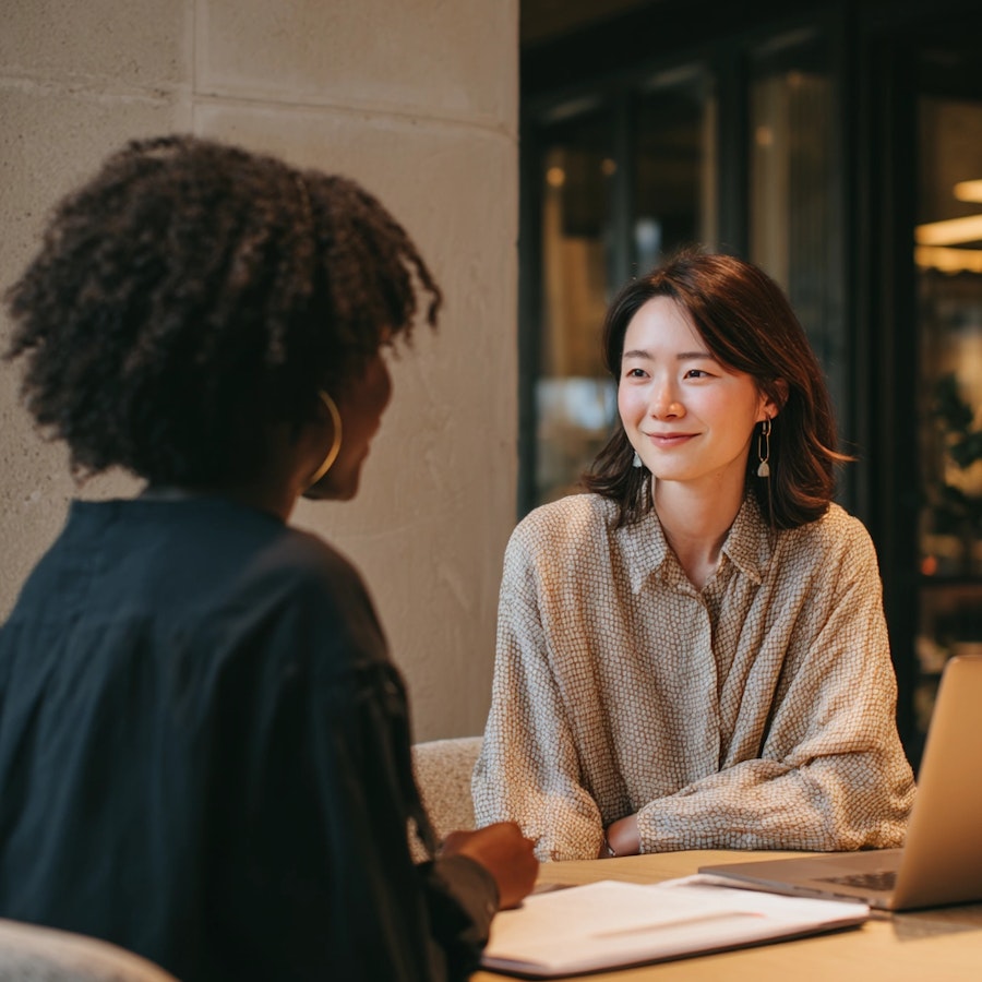 Two people engaged in an in-depth interview during a qualitative research session, representing global market research and participant-moderator interaction.